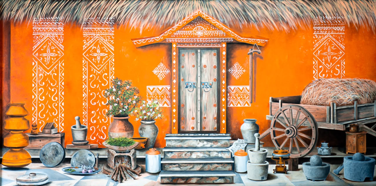 The sunlit facade of a traditional mud home, its ochre walls adorned with white Mandana motifs painted by generations of women. A thatched roof, a laden bullock cart, grinding stones, and vessels of clay and metal — every object speaks of a household at work. A tribute to the quiet dignity, order and beauty of everyday rural Indian life.