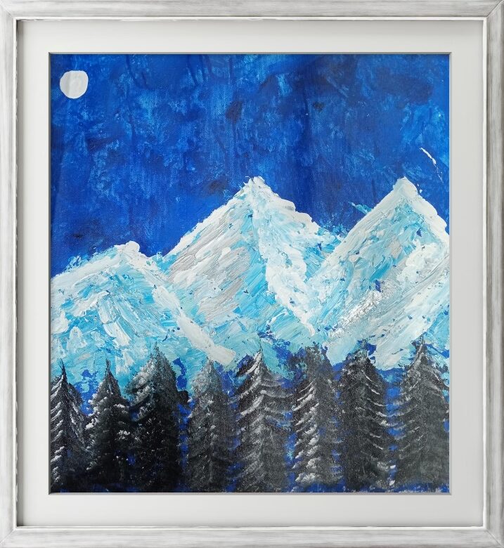 Moonlit Peaks by Avyukt Ohri. Snow-covered mountains in white and ice blue rise above dark evergreens beneath a deep blue sky, with a small pale moon at the upper left. Cool, textured and peaceful.